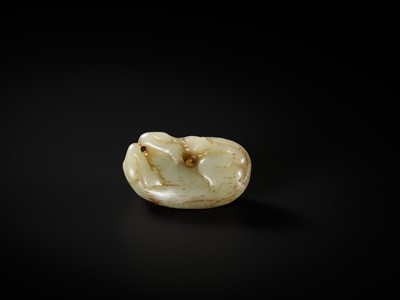 Lot 336 - A CELADON AND RUSSET JADE FIGURE OF A RAM, QING DYNASTY