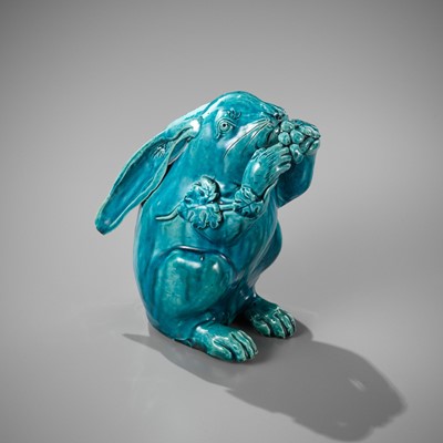 Lot 438 - A TURQUOISE-GLAZED FIGURE OF A HARE EATING GRAPES, JIAQING