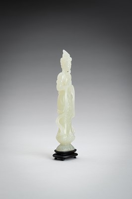 Lot 161 - A PALE CELADON JADE CARVING OF A GUANYIN, 1900s