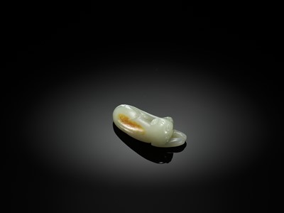 Lot 139 - A PALE CELADON JADE CARVING OF A DOG, QING