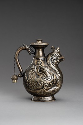 Lot 255 - AN ARCHAISTIC ‘PHOENIX AND DRAGON’ METAL EWER, 1920s