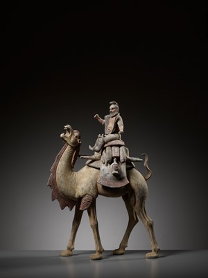Lot 69 - A MASSIVE PAINTED POTTERY FIGURE OF A BACTRIAN CAMEL AND SOGDIAN RIDER, TANG DYNASTY