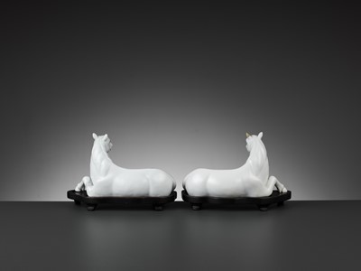 Lot 595 - A PAIR OF WHITE-GLAZED FIGURES OF HORSES, QING DYNASTY