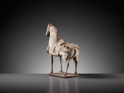 Lot 50 - A PAINTED POTTERY FIGURE OF A CAPARISONED HORSE, EASTERN WEI DYNASTY