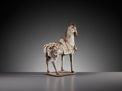Lot 50 - A PAINTED POTTERY FIGURE OF A CAPARISONED HORSE, EASTERN WEI DYNASTY