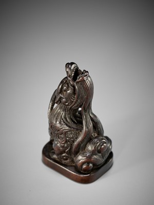 Lot 1416 - A FINE WOOD NETSUKE OF A BAYING KIRIN IN THE STYLE OF MITSUHARU