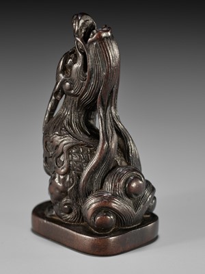 Lot 1416 - A FINE WOOD NETSUKE OF A BAYING KIRIN IN THE STYLE OF MITSUHARU