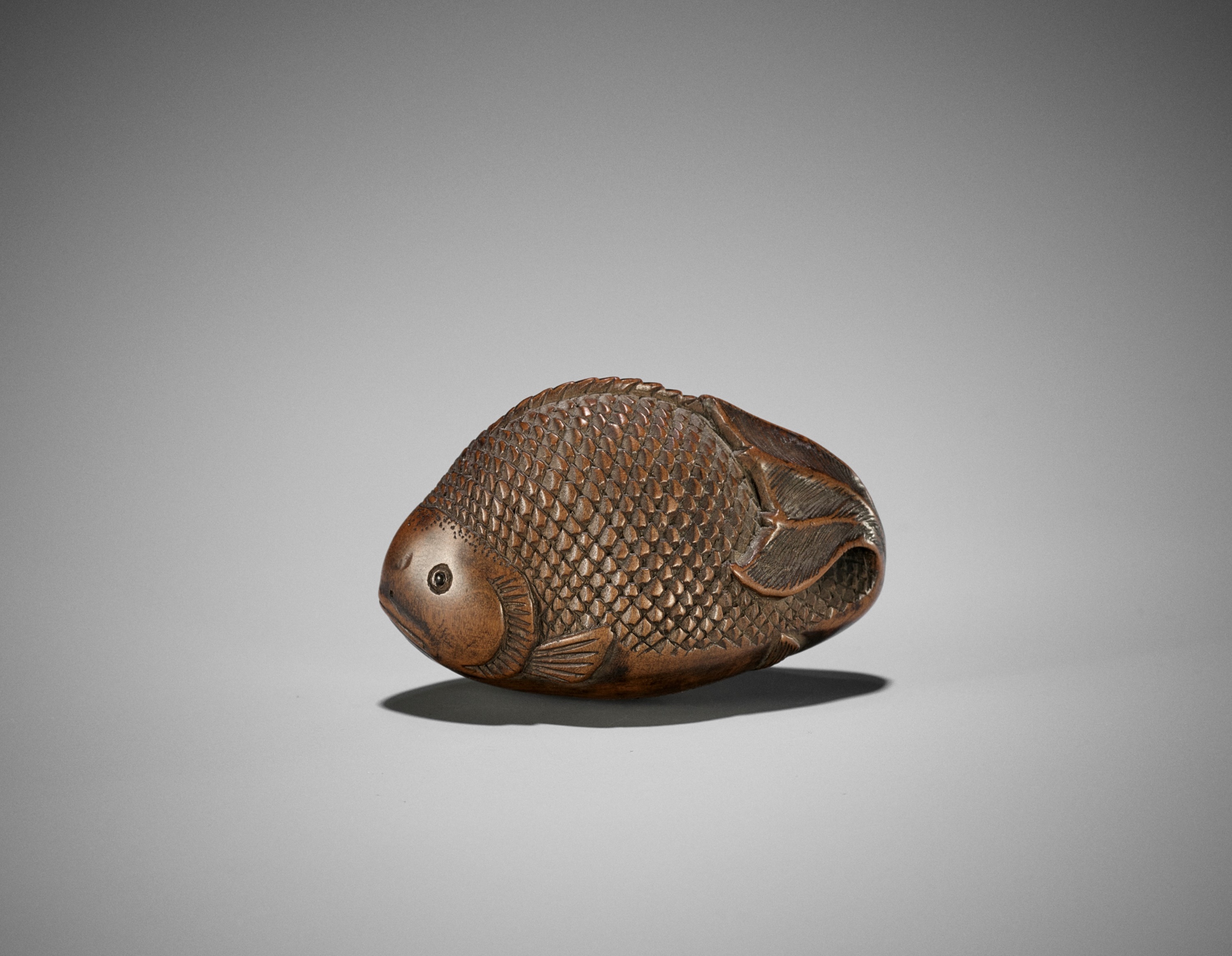 Lot 78 - TOYOKAZU: A FINE WOOD NETSUKE OF A CARP