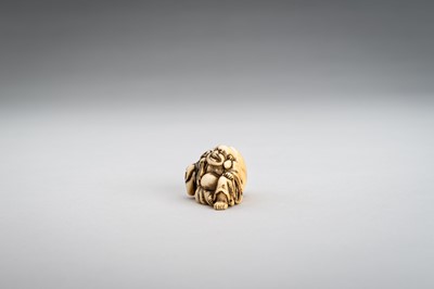 Lot 374 - AN IVORY NETSUKE OF HOTEI WITH HIS TREASURE BAG