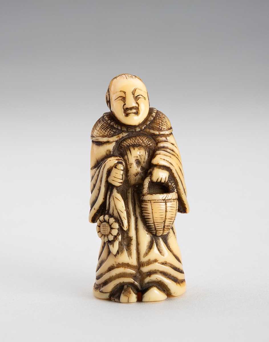 Lot 1487 - A TOOTH NETSUKE OF OTA DOKAN CARRYING A