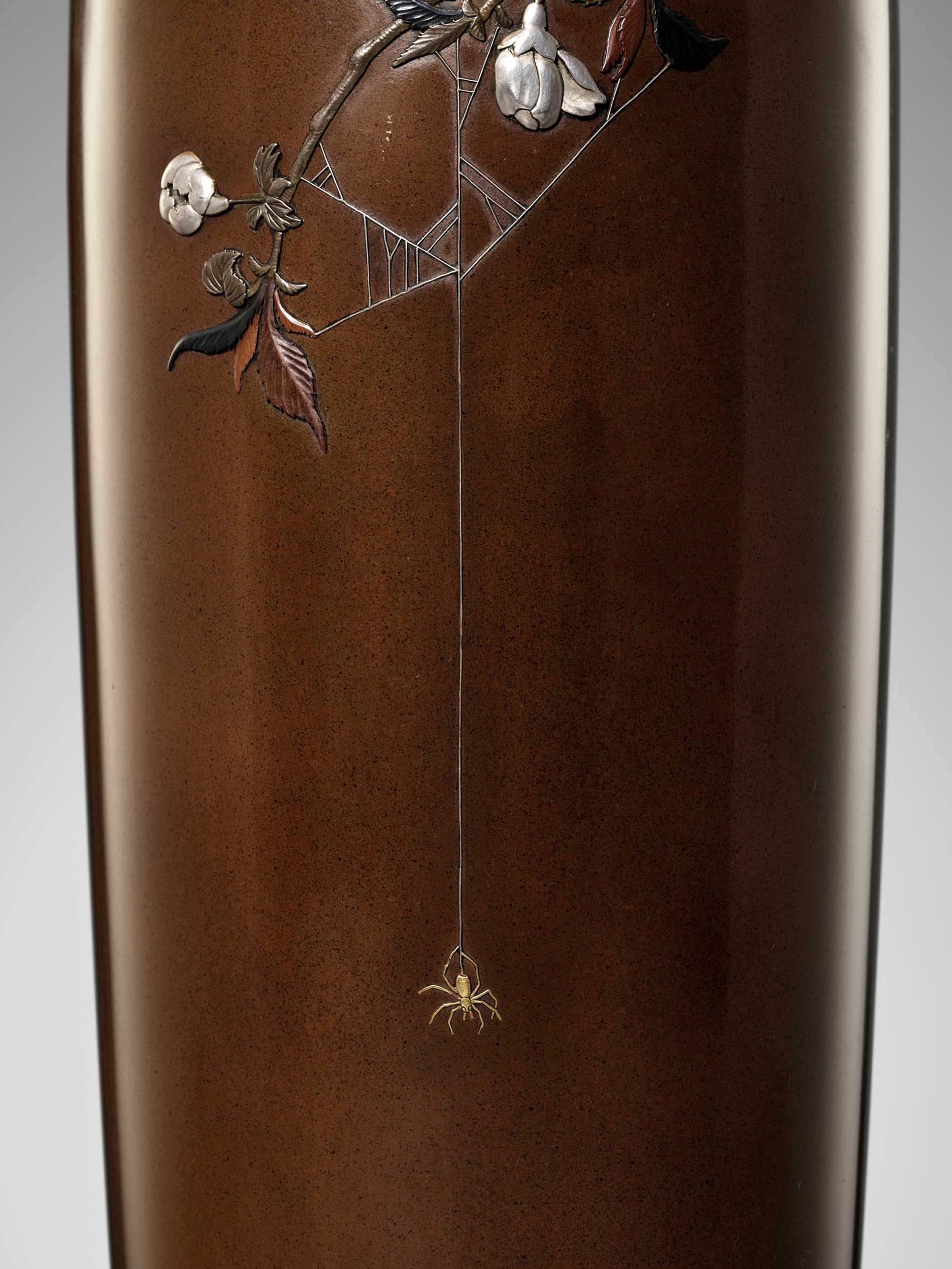 Lot 62 - OTSUEI FOR THE NOGAWA COMPANY: A MASTERFUL INLAID BRONZE VASE DEPICTING A SPIDER HANGING FROM A PLUM BRANCH