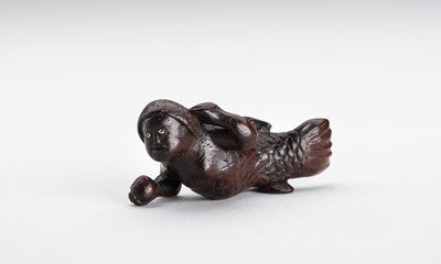 Lot 646 - A WOOD NETSUKE OF A SWIMMING NINGYO (MERMAID)