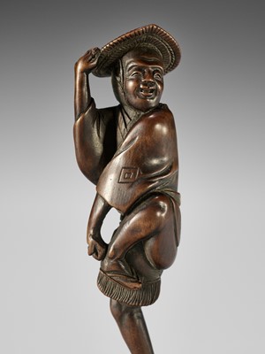 Lot 601 - TOMOCHIKA: A SUPERB AND RARE WOOD NETSUKE OF A SPARROW DANCER (SUZUME ODORI)