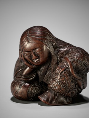 Lot 1449 - TADATOSHI: A SUPERB NAGOYA SCHOOL WOOD NETSUKE OF A SEATED SLEEPING SHOJO