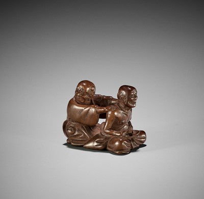 MIWA: A WOOD NETSUKE OF A BLIND MASSEUR AND CLIENT