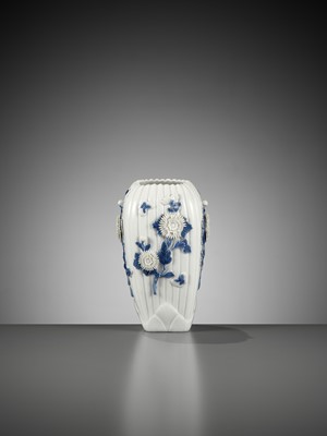 Lot 117 - A MOLDED AND CARVED HIRADO BLUE AND WHITE VASE WITH CHRYSANTHEMUMS AND BUTTERFLIES