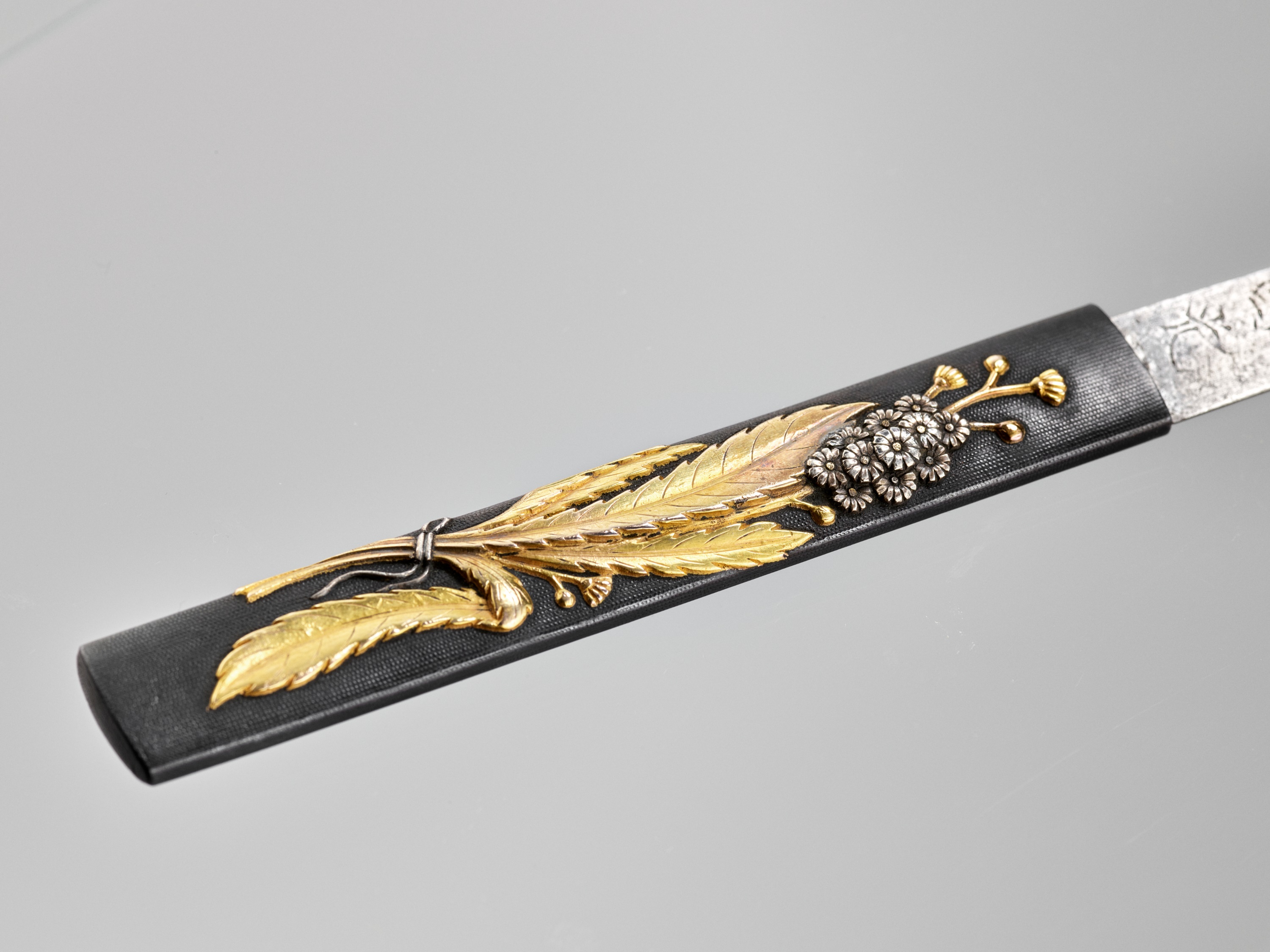 Lot 149 - A GOLD AND SILVER-INLAID SHAKUDO KOZUKA WITH