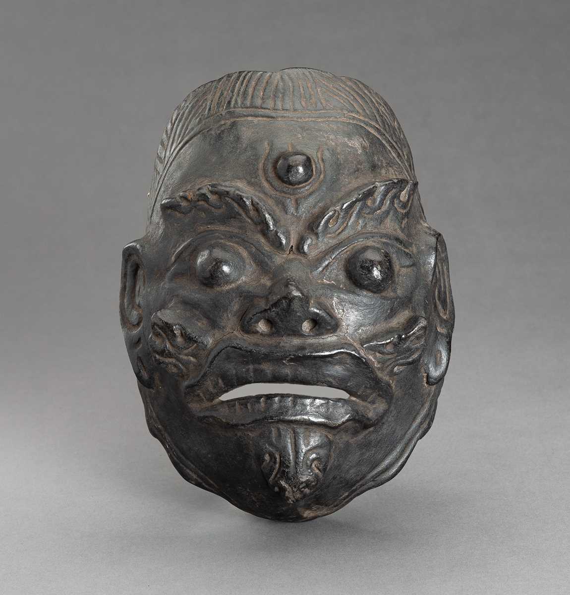 Lot 310 - A BLACK LACQUERED WOOD MASK OF WRATHFUL DEITY