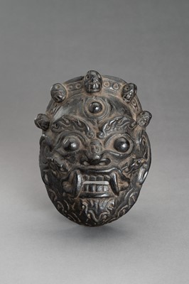 Lot 309 - A BLACK LACQUERED WOOD MASK OF BHAIRAVA