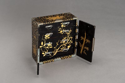 Lot 180 - A BLACK AND GOLD LACQUER MINIATURE CABINET