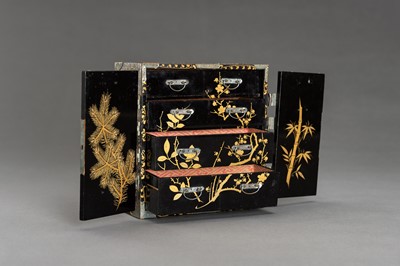 Lot 180 - A BLACK AND GOLD LACQUER MINIATURE CABINET