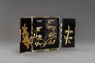 Lot 180 - A BLACK AND GOLD LACQUER MINIATURE CABINET