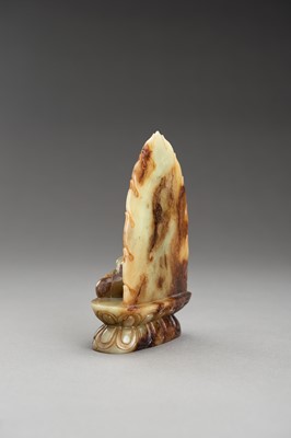 Lot 178 - A PALE CELADON AND RUSSET JADE FIGURE OF BUDDHA