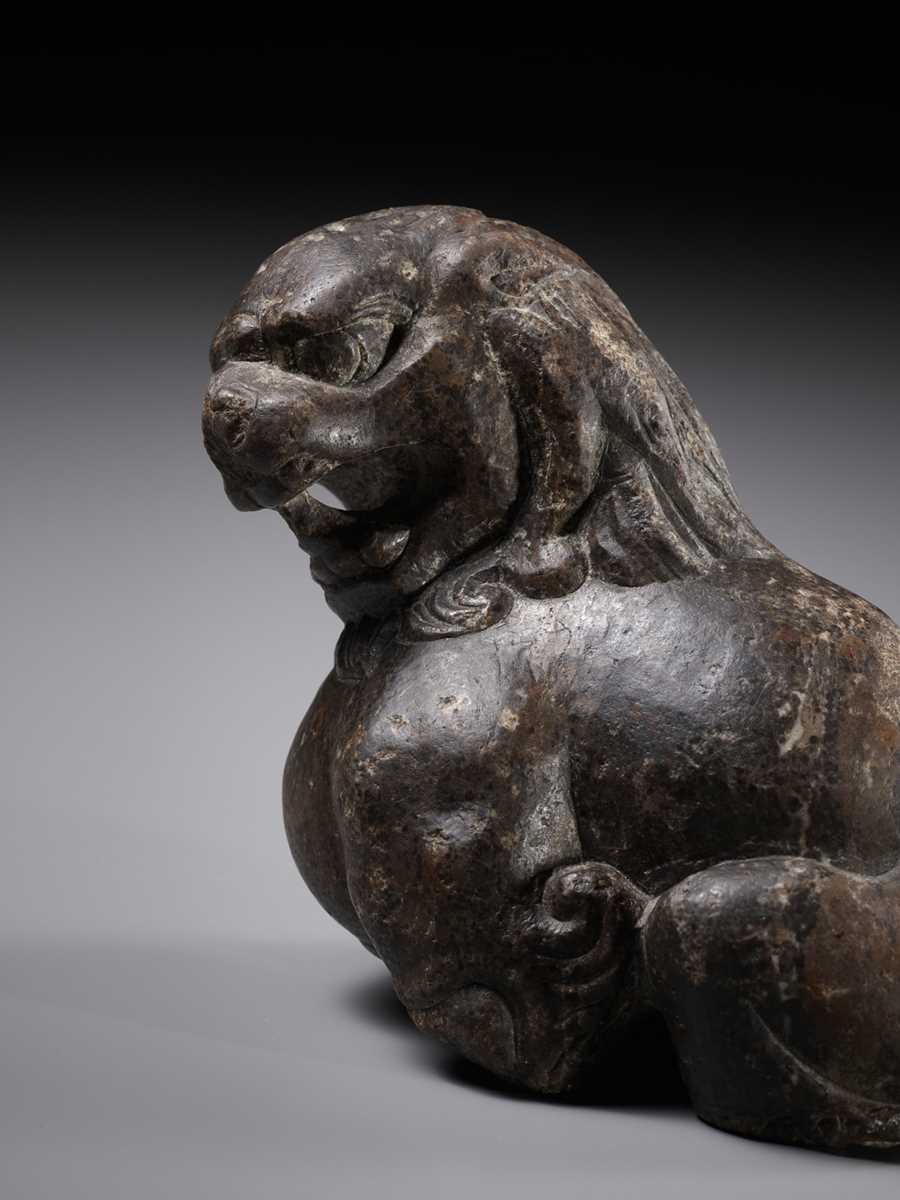 A BROWN LIMESTONE FIGURE OF A SEATED LION, TANG DYNASTY