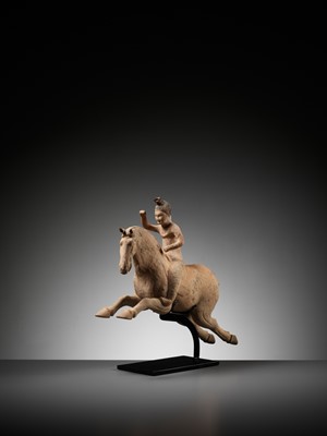Lot 62 - A PAINTED POTTERY FIGURE OF A POLO PLAYER, SUI TO TANG DYNASTY