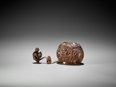 Lot 180 - SHUOSAI: AN INLAID WOOD TONKOTSU DEPICTING MONKEYS AND PEACHES WITH EN-SUITE NETSUKE AND OJIME
