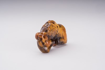 Lot 51 - A RARE AMBER CARVING OF A BUDDHIST LION WITH BALL
