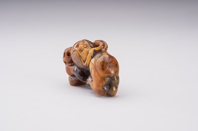 Lot 51 - A RARE AMBER CARVING OF A BUDDHIST LION WITH BALL