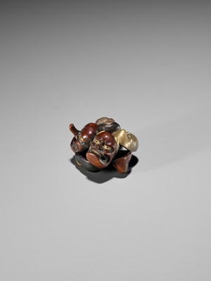 Lot 265 - A LACQUER NETSUKE OF A CLUSTER OF MASKS