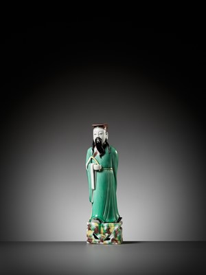 Lot 397 - A GREEN, YELLOW AND AUBERGINE-GLAZED BISCUIT FIGURE OF A DAOIST IMMORTAL, KANGXI PERIOD