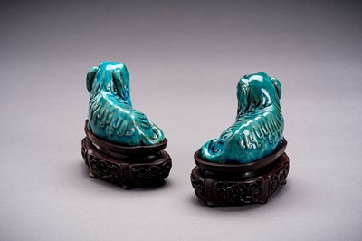 Lot 594 - A PAIR OF TURQUOISE GLAZED PORCELAIN BUDDHIST LIONS, QING