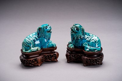 Lot 594 - A PAIR OF TURQUOISE GLAZED PORCELAIN BUDDHIST LIONS, QING