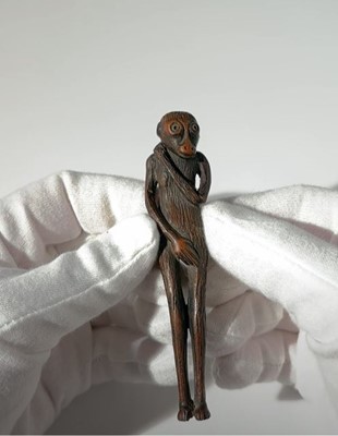 Lot 12 - AN UNUSUAL TALL WOOD NETSUKE OF MYTHICAL CREATURE