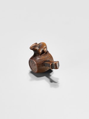 Lot 341 - A WOOD NETSUKE OF A RAT ON DAIKOKU’S WISH-GRANTING MALLET