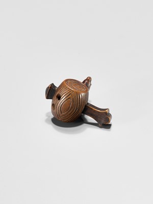Lot 341 - A WOOD NETSUKE OF A RAT ON DAIKOKU’S WISH-GRANTING MALLET