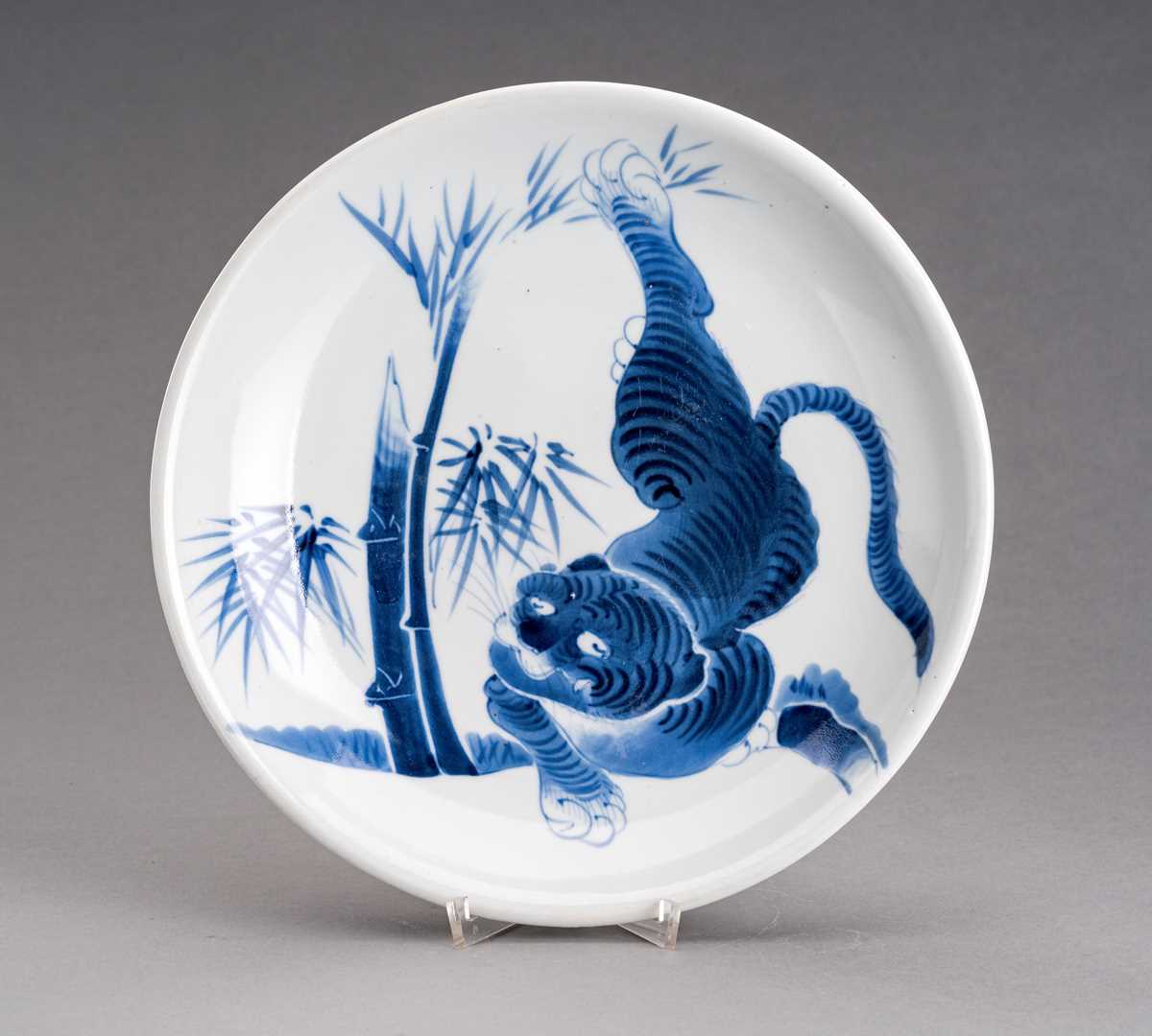 Lot 1210 - A BLUE AND WHITE ARITA IMARI PORCELAIN DISH ‘TIGER AND BAMBOO’, MEIJI