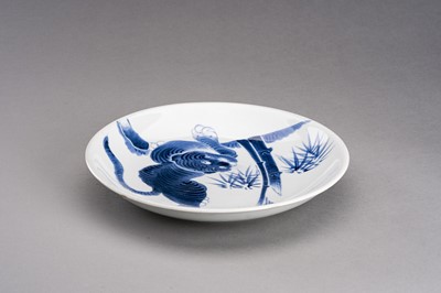 Lot 1210 - A BLUE AND WHITE ARITA IMARI PORCELAIN DISH ‘TIGER AND BAMBOO’, MEIJI