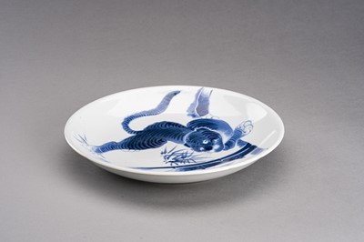 Lot 1210 - A BLUE AND WHITE ARITA IMARI PORCELAIN DISH ‘TIGER AND BAMBOO’, MEIJI