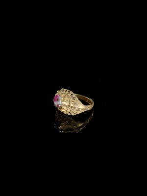 Lot 311 - A CORUNDUM-SET GOLD ‘FLOWERS AND BIRD’ PRIEST’S RING