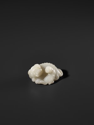 Lot 325 - A WHITE JADE WEIGHT OF A BUDDHIST LION WITH CUB, 17TH CENTURY