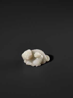 Lot 325 - A WHITE JADE WEIGHT OF A BUDDHIST LION WITH CUB, 17TH CENTURY