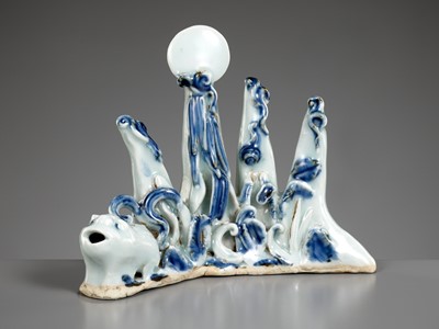 Lot 425 - A BLUE AND WHITE ‘MOUNTAIN’ BRUSHREST WITH AN INTEGRAL ‘XINIU’ WATERDROPPER, QING DYNASTY