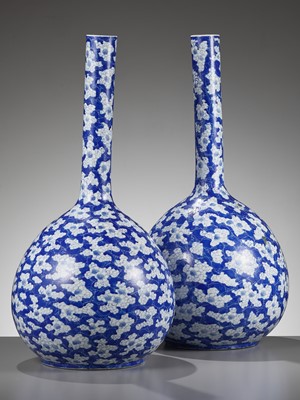 Lot 244 - A PAIR OF BLUE AND WHITE ‘ICE CRACK AND PRUNUS’ BOTTLE VASES, 19TH CENTURY