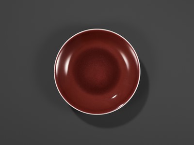 Lot 217 - A COPPER-RED GLAZED DISH, WITH A LIVER-RED GLAZE POOLING IN THE WELL, QIANLONG MARK AND PERIOD