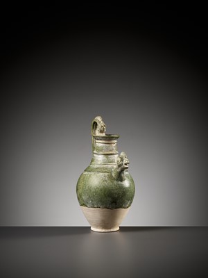 Lot 354 - A GREEN GLAZED ‘CHICKEN HEAD’ EWER, TANG TO LIAO DYNASTY