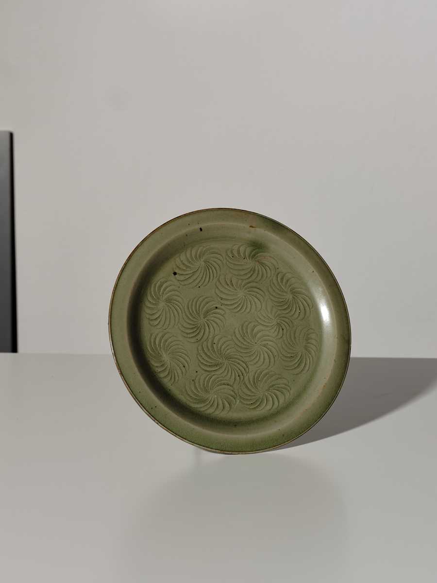 Lot 371 - A YAOZHOU CELADON CARVED DISH, SONG DYNASTY